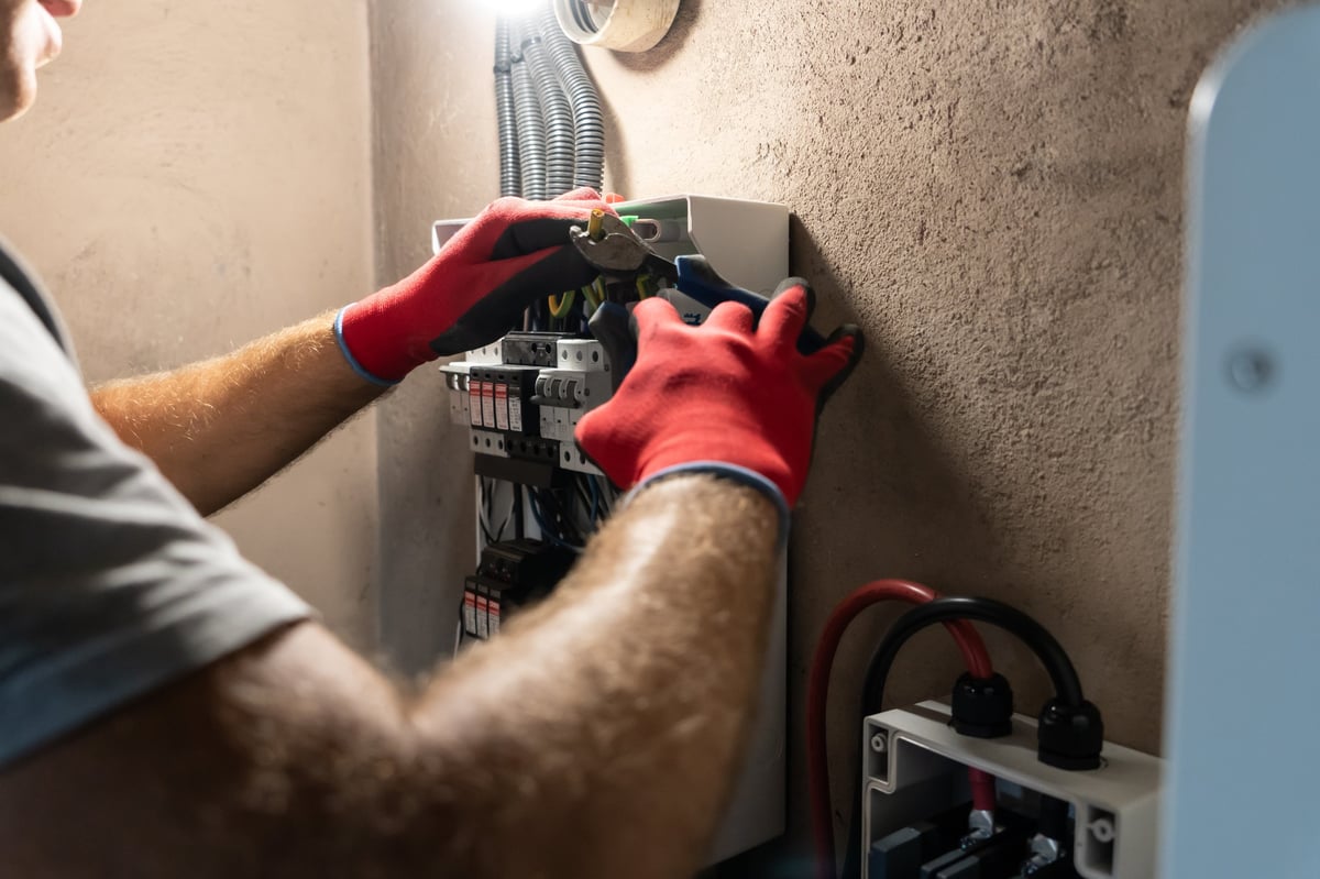 Electrician testing a residential electrical panel