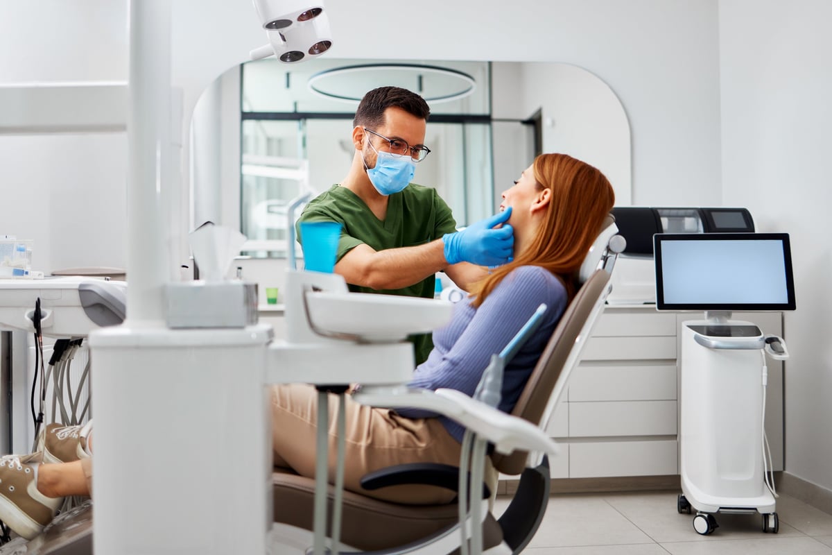 Dentist examining a patient's teeth in a modern dental clinic